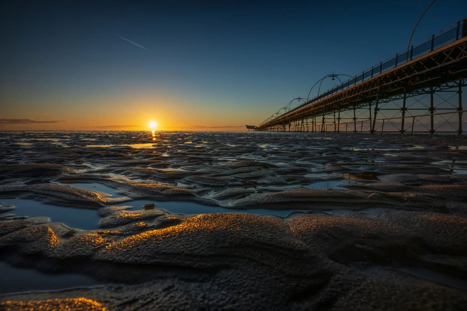 Southport Beach at low tide — wide flat sand stretching to the sea