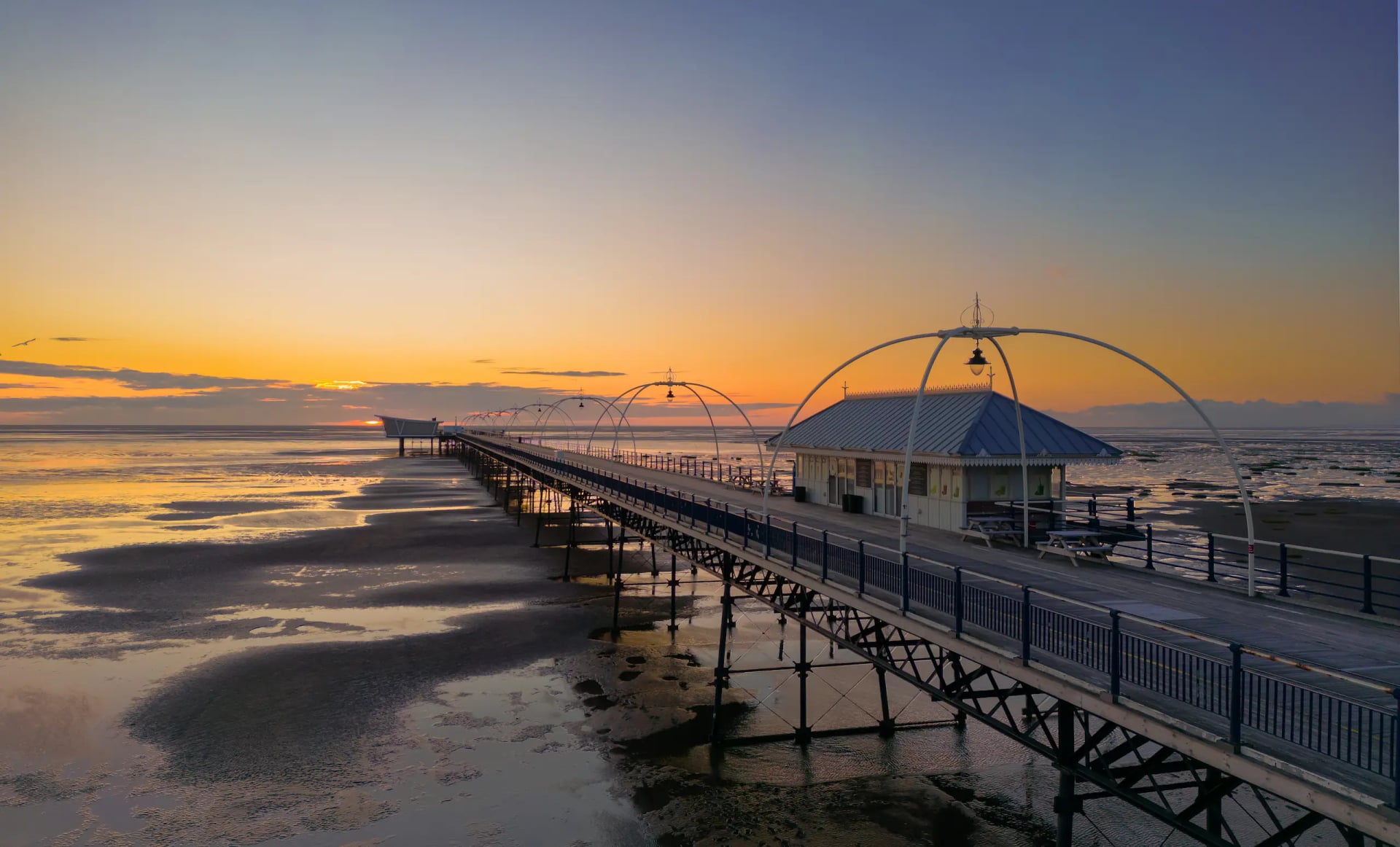 Southport Pier stretching out over the Irish Sea at dusk